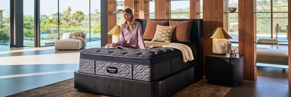 beautyrest-black-series-4-woman-sitting-on-bed